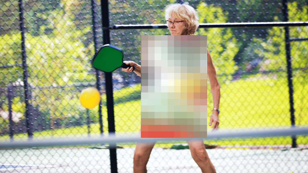 A women plays nude pickleball on an outdoor court