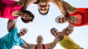 athletic women huddle in a circle 